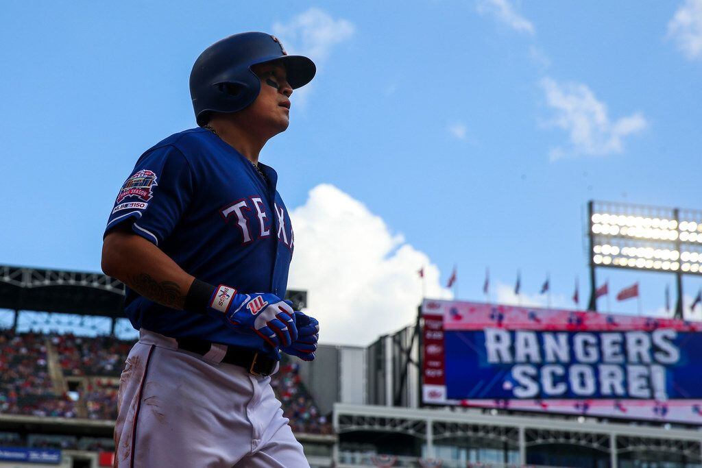 Texas Rangers left fielder Shin-Soo Choo (17) runs back the dugout after scoring during a...