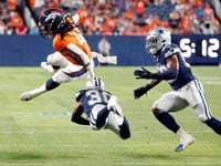 Denver Broncos safety Jamar Johnson (41) hurdles Dallas Cowboys cornerback DaRon Bland (30)...