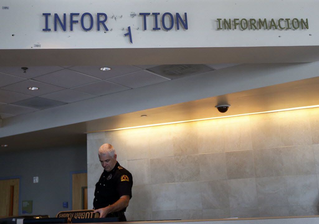 A sign hanging above the front desk at the Dallas Police Department's Jack Evans Police...