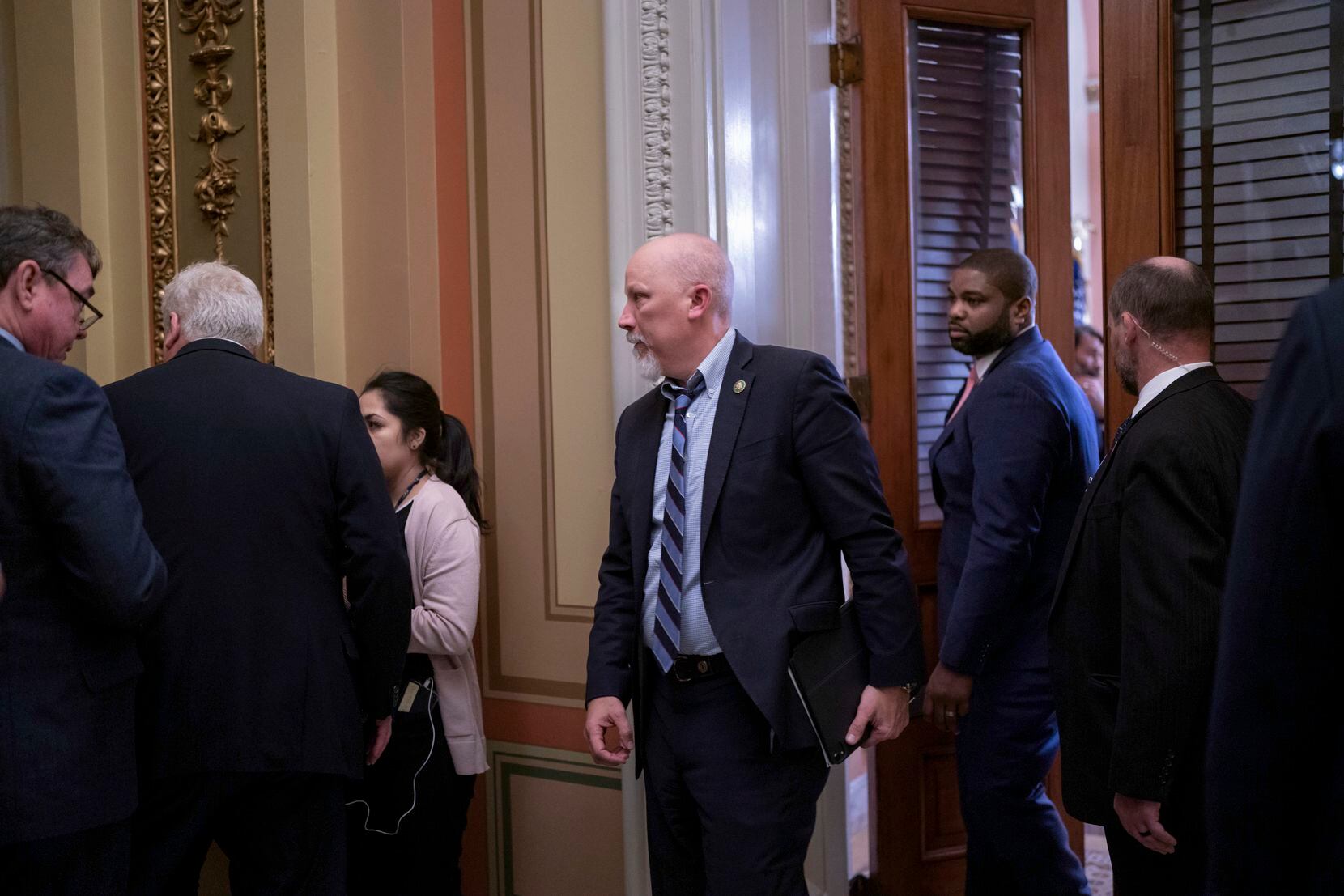 Rep. Chip Roy, R-Texas, center, followed by Rep. Byron Donalds, R-Fla., right, leaves a...