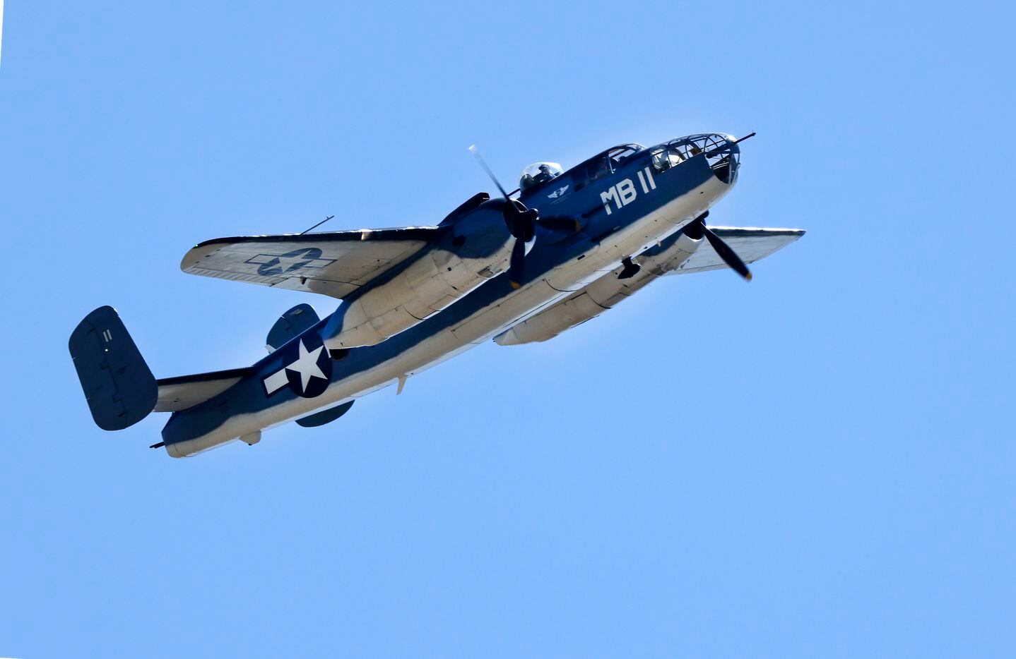 A B-25 Mitchell bomber made several passes over training camp practice in Oxnard,...