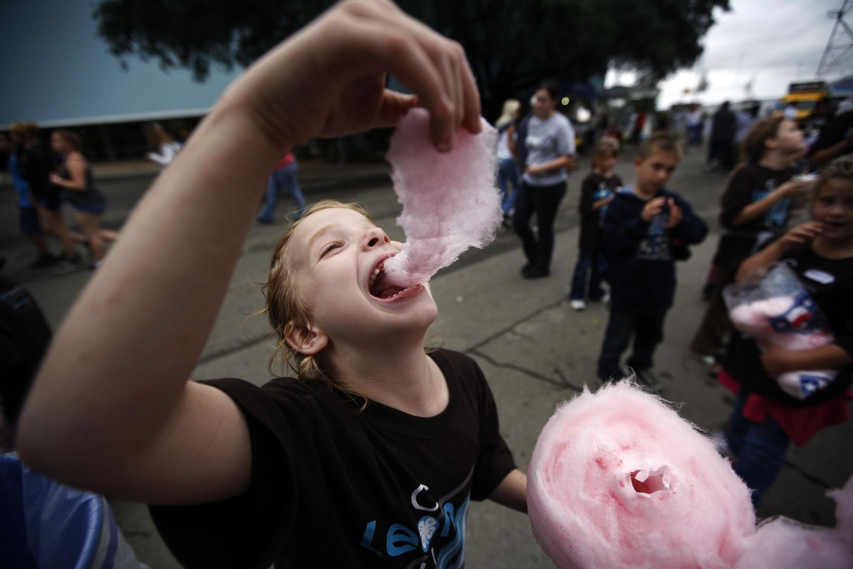 Although the State Fair of Texas won't operate in 2020, a select number of fairgoers can still eat fair food. Here, Presley Lindsay, 7, of Buffalo, Texas, enjoys cotton candy at the State Fair of Texas in 2009. The State Fair of Texas has been in operation for 134 years.