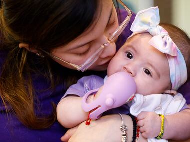 Natalie Zamora, sister of late Gabriel Zamora, 14, kisses four-month-old daughter Adelina...