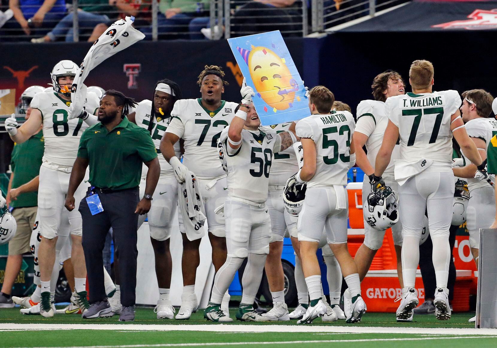 It seems like party time on the Baylor bench, as the bears pull ahead during first half of the Big 12 Championship football game between Oklahoma State and Baylor at AT&T Stadium in Arlington on Saturday, December 4, 2021. (John F. Rhodes / Special Contributor)