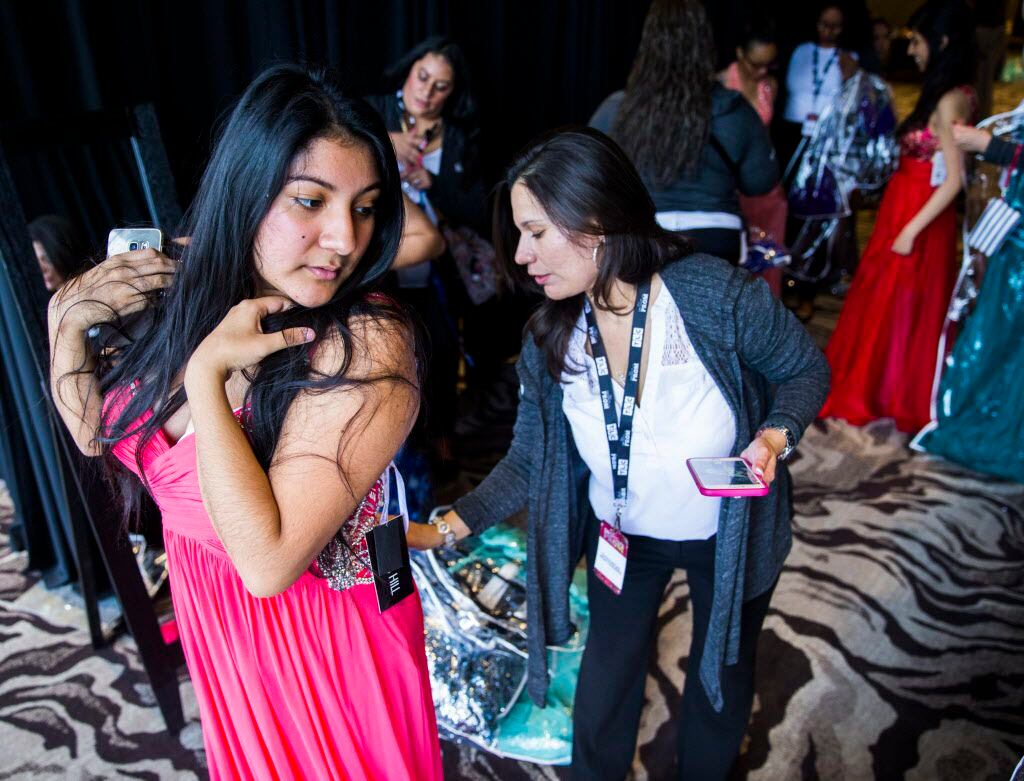 H. Grady Spruce High School student Edith Delgado, 17, tries on a prom dress with her...