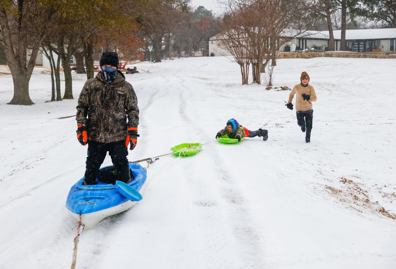 Case Paty (front), 12, looks forward as Cam Paty (center), 7, holds on and Miles Alford, 11,...