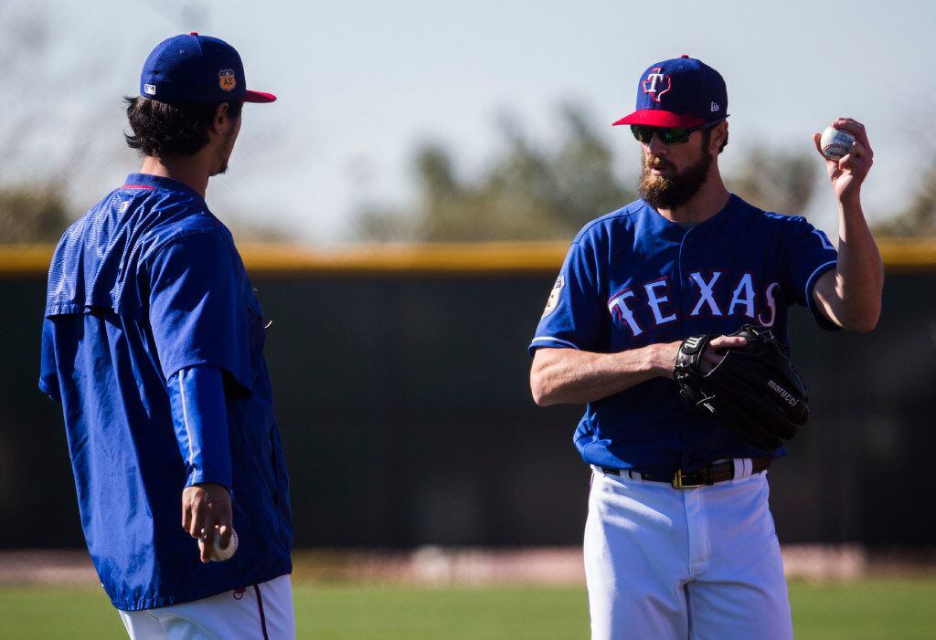 Texas Rangers starting pitcher Yu Darvish (11) and starting pitcher Cole Hamels (35) consult...