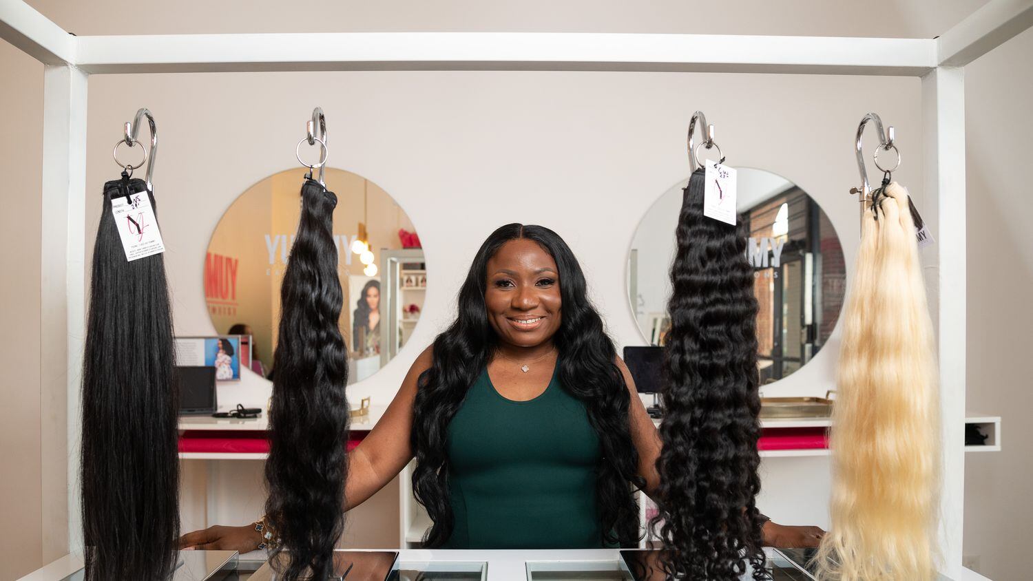 Yummie O., founder and chief executive officer of Yummy Extensions shown at her shop in...
