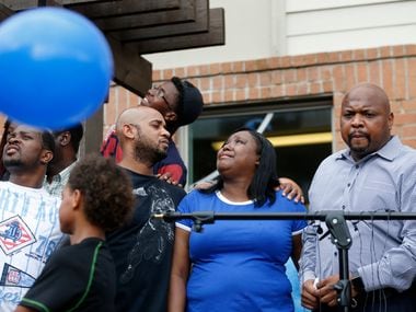 Tina Tyler (center) watches as balloons are released in the sky during a vigil for her son Malik Tyler at the Sterlingshire Apartments near the scene of the shooting in Dallas on Wednesday, June 5, 2019. Tyler was injured and killed in crossfire in the 9400 block of Bruton Road Tuesday night. Next to Tina is her boyfriend Christopher White (left) and Terrence Perkins (right). (Vernon Bryant/The Dallas Morning News)