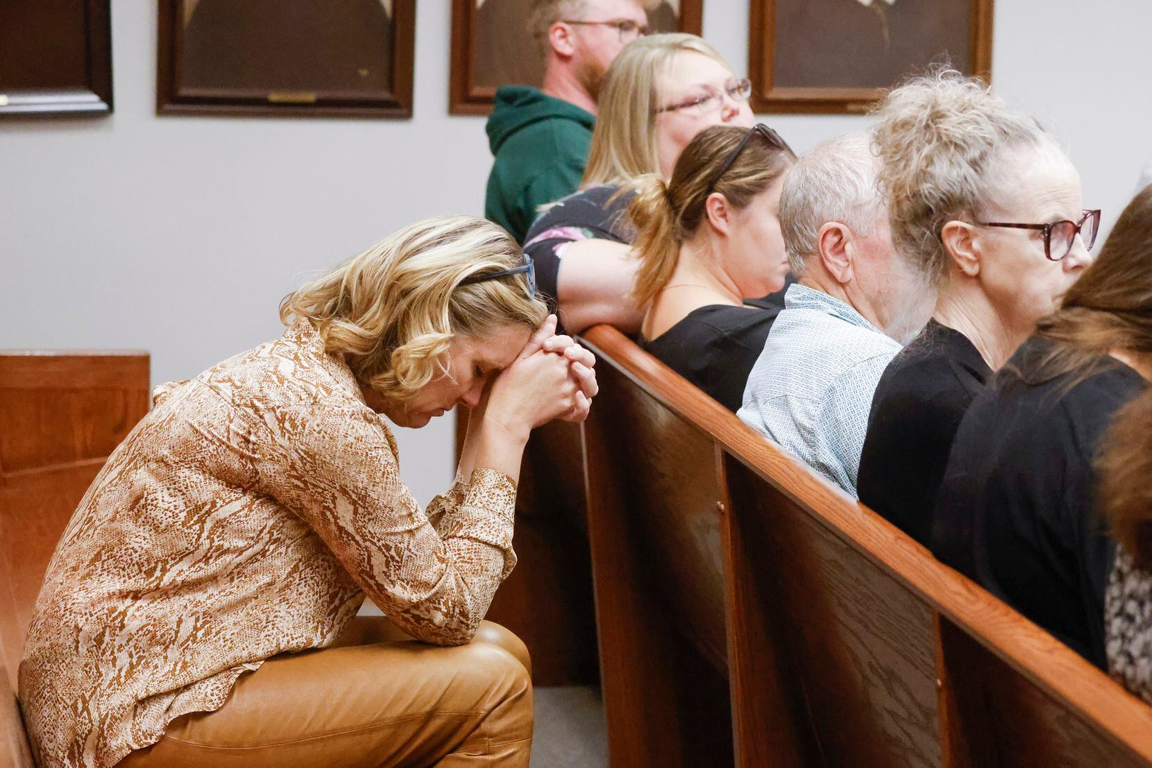 Friends and family members of deceased Jonathan Crews listen to the 911 call recording of...