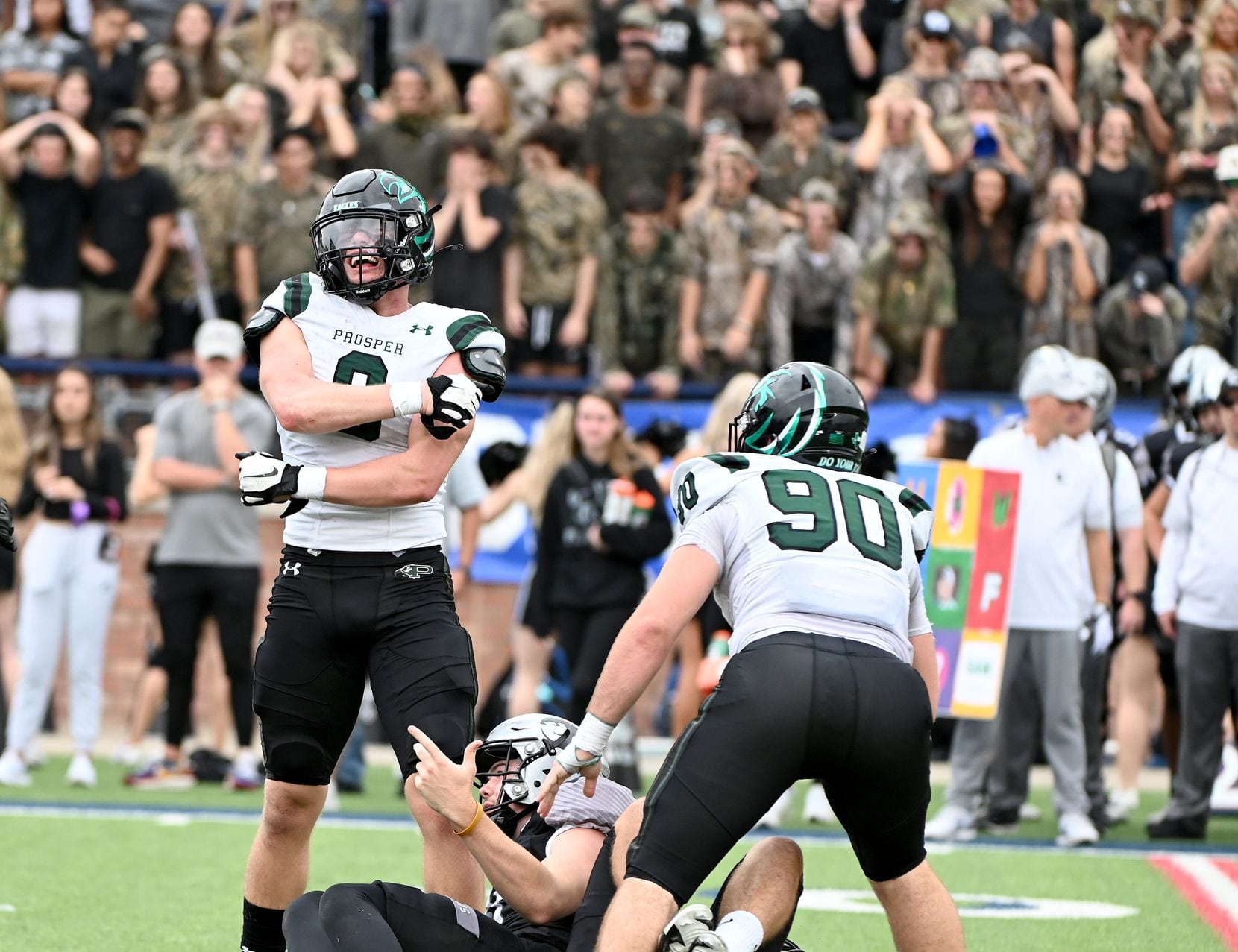 Prosper’s Aeden Combest (9) and Justin Endicott (90) celebrate after sacking Denton Guyer's Jackson Arnold (11) in the first half of a Class 6A Division II Region I final high school playoff football game between Denton Guyer and Prosper, Saturday, Dec. 4, 2021, in Allen, Texas. Celina won 34-0. (Matt Strasen/Special Contributor)