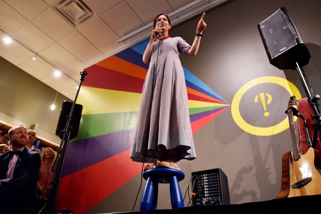 Author Ann Patchett stands on a small stool as she speaks about independent bookstores...