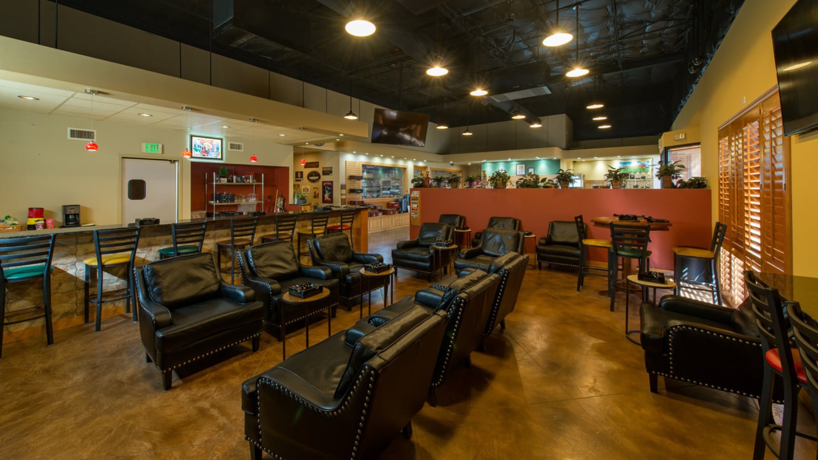 A photo of the Renegade Cigars lounge with black lounge chairs.