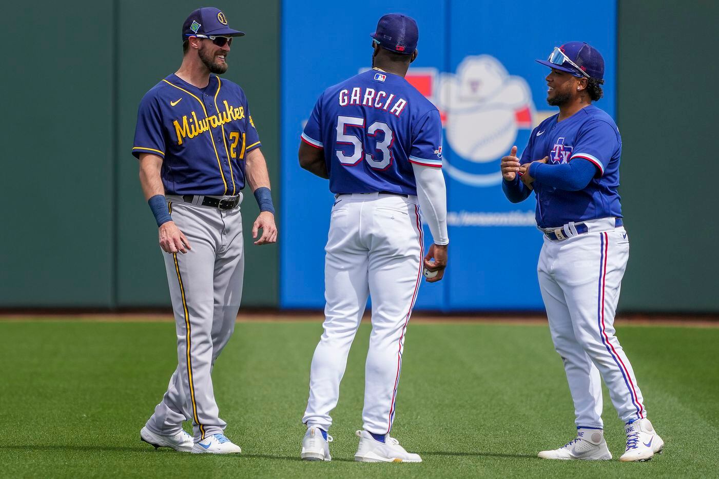 Milwaukee Brewers designated hitter David Dahl chats with former Texas Rangers teammates...