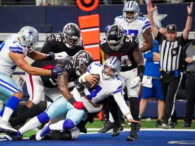 Dallas Cowboys quarterback Dak Prescott (4) pushes into the end zone to score on a four-yard touchdown  run on a fourth-and-two play during the second half of an NFL football game against the Atlanta Falcons at AT&T Stadium on Sunday, Nov. 14, 2021, in Arlington.