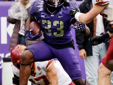 TCU Horned Frogs running back Kendre Miller (33) fights his way past several Iowa State...