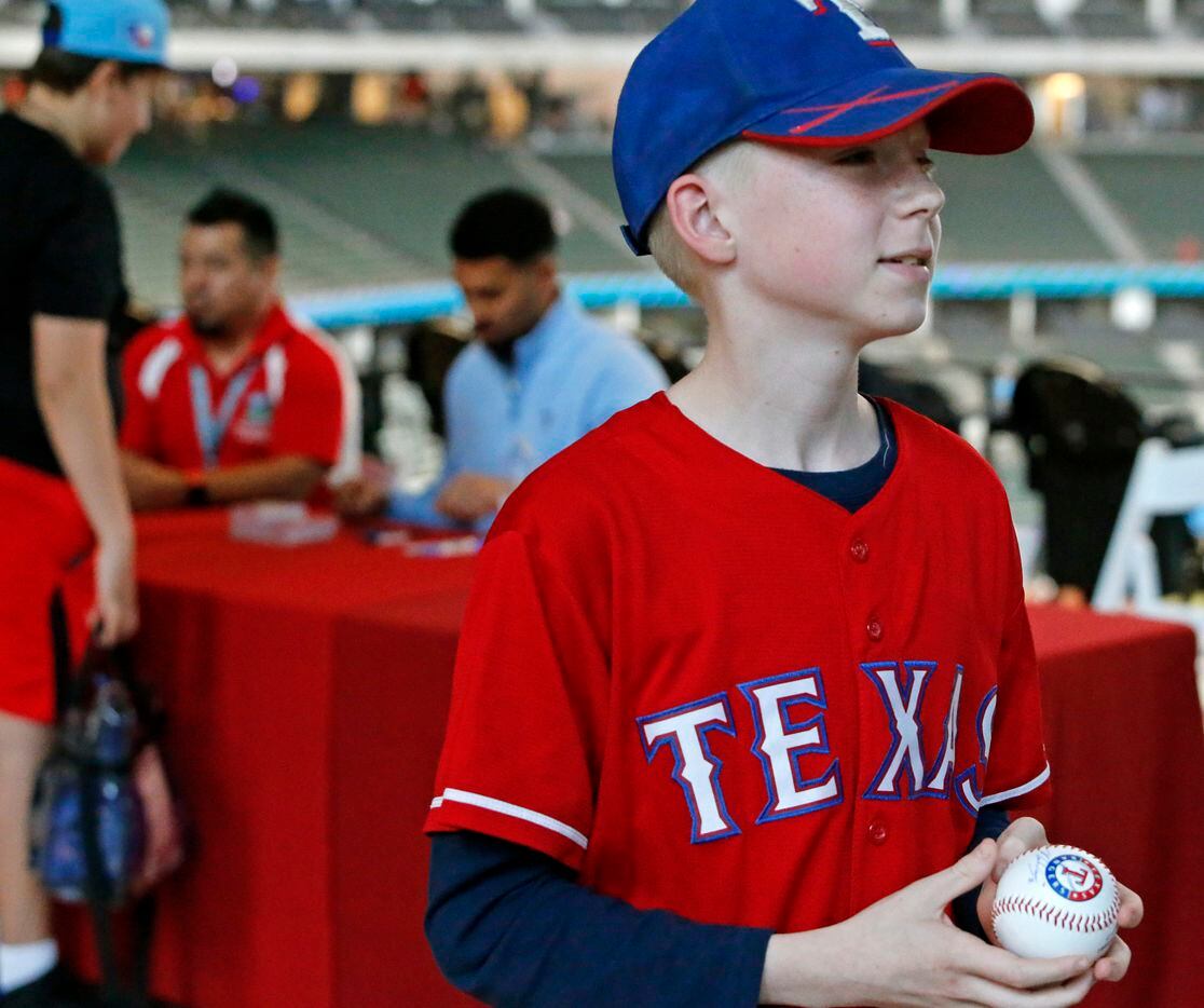 Jacob Streeter, 12, or Burleson, walks away with an autographed baseball from Texas Rangers...
