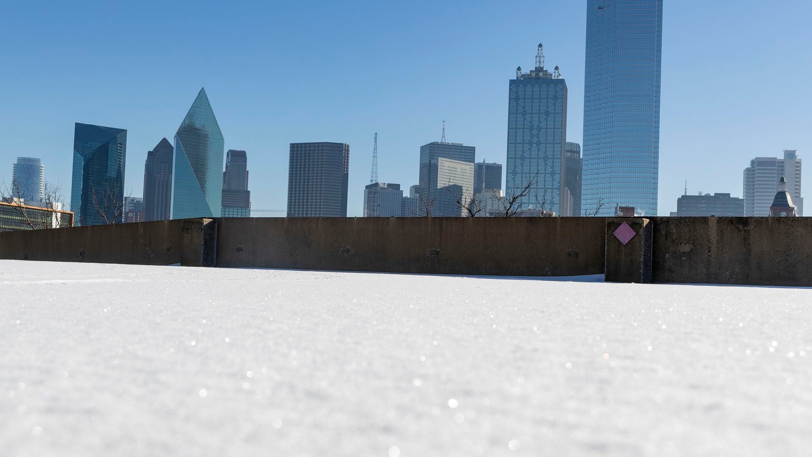 The Dallas skyline, seen from the top of a snow-covered parking garage on Feb. 5, 2022....