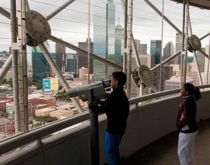 Jalen Williams and his sister takes in the view of downtown Dallas on the observation deck...