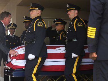 The casket of Officer Rogelio Santander is carried to the hearse after the funeral at Lake...