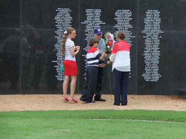 The Trovillian family helps place a wreath near the Wall of Honor at the Collin County...