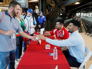 Tabor Smith (left) of Aledo gets an autograph on his baseball from Texas Rangers shortstop...