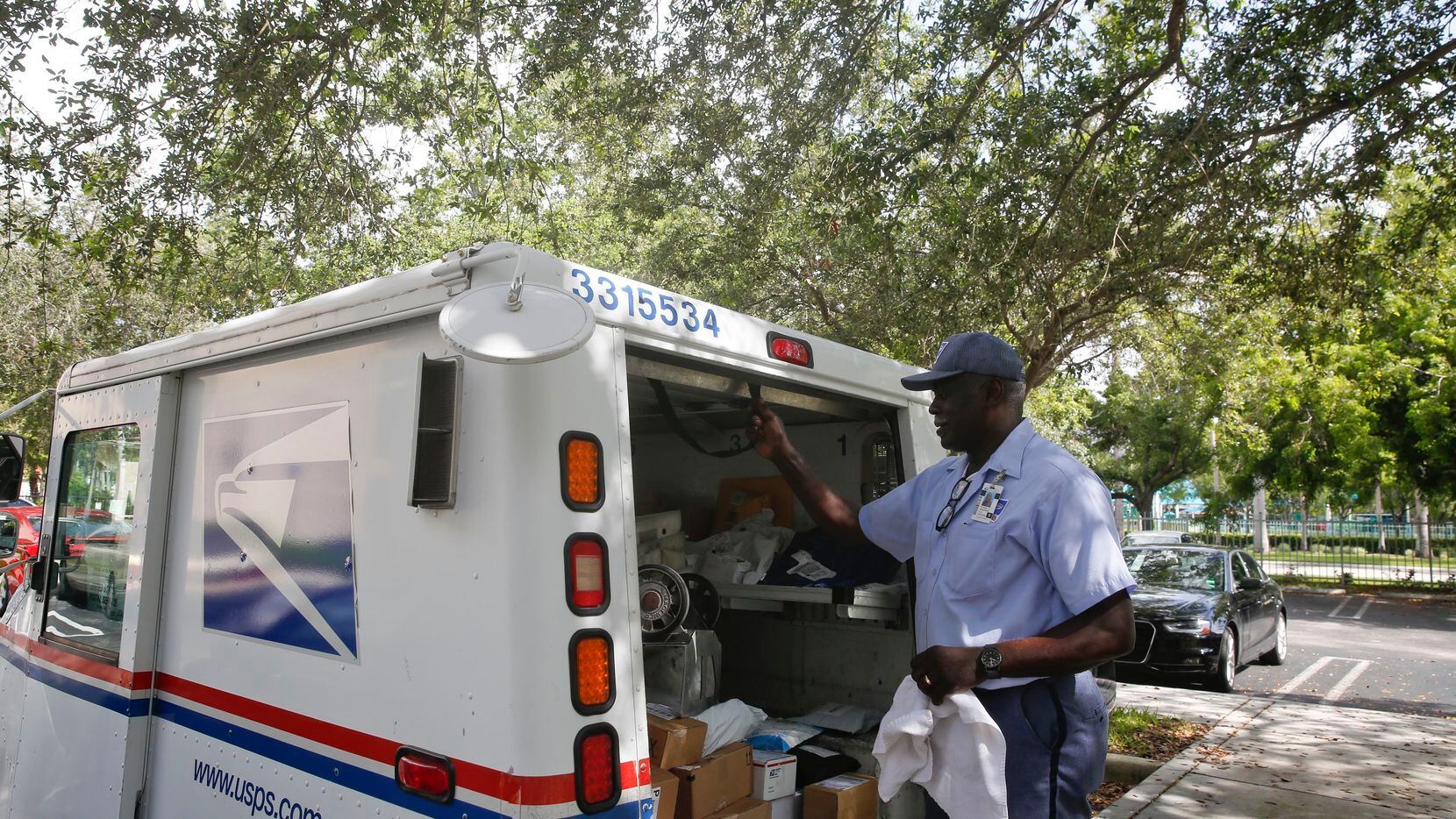 In this 2018 file photo, Elston Bradshaw delivers mail to an apartment complex in Florida. The federal government employs more people than any single company.