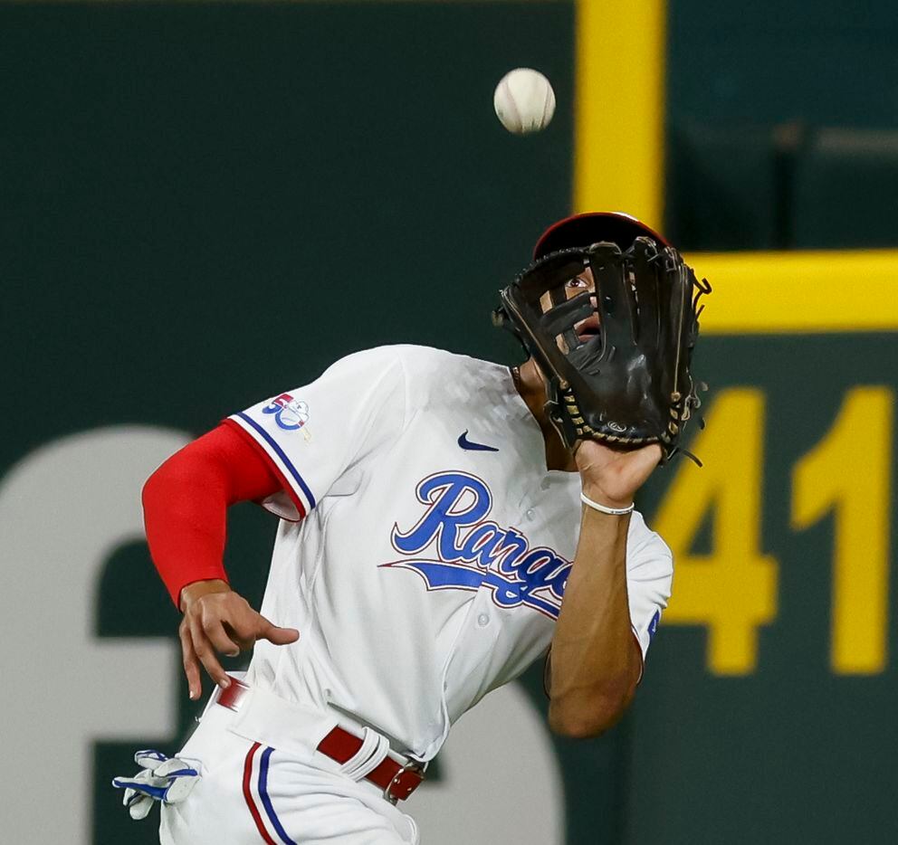 Texas Rangers center fielder Bubba Thompson (65) makes a catch for an out during the seventh...