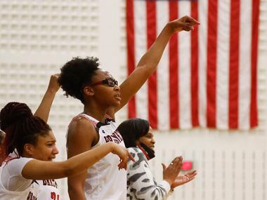 Braswell’s Alisa Williams cheers from the bench during a district 5-6A basketball game...