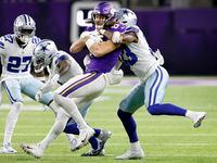 Dallas Cowboys linebacker Damone Clark (33) throws Minnesota Vikings tight end T.J....