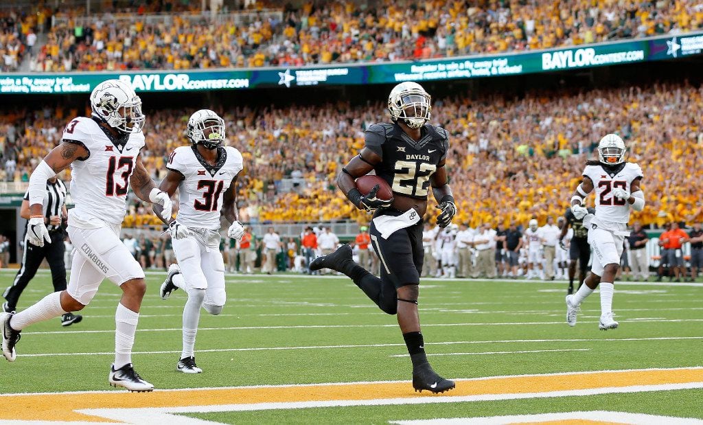 Baylor running back Terence Williams (22) scores a 23-yard touchdown past Oklahoma State...