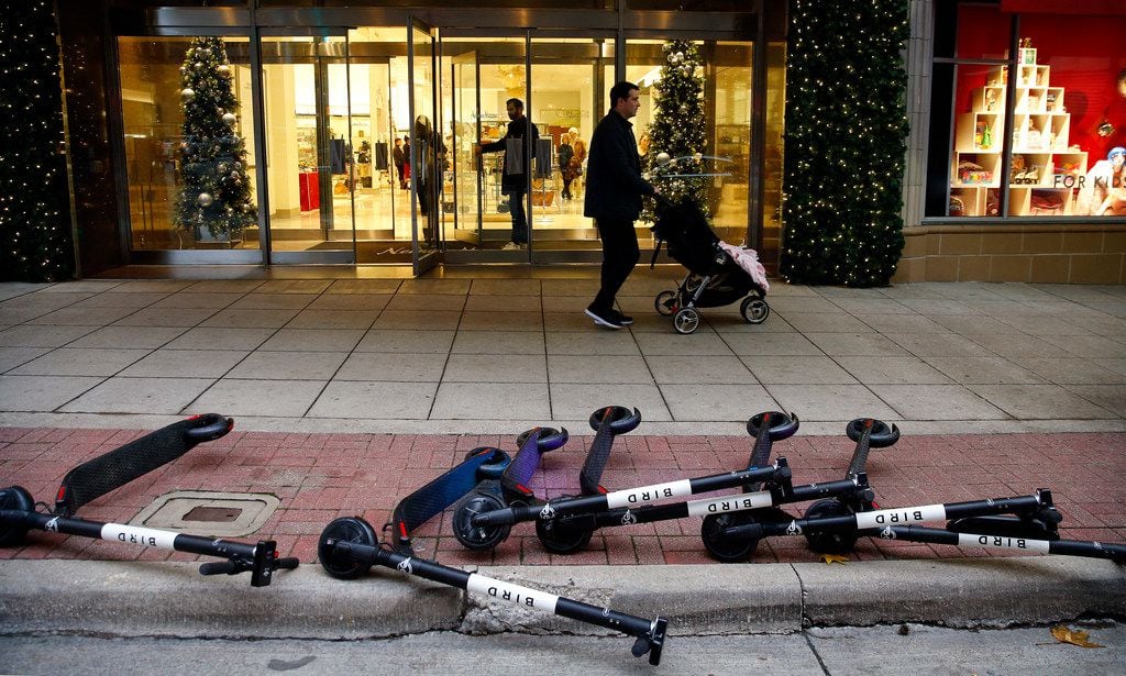 BIRD electric rental scooters lie on the ground outside the Neiman Marcus store in downtown...