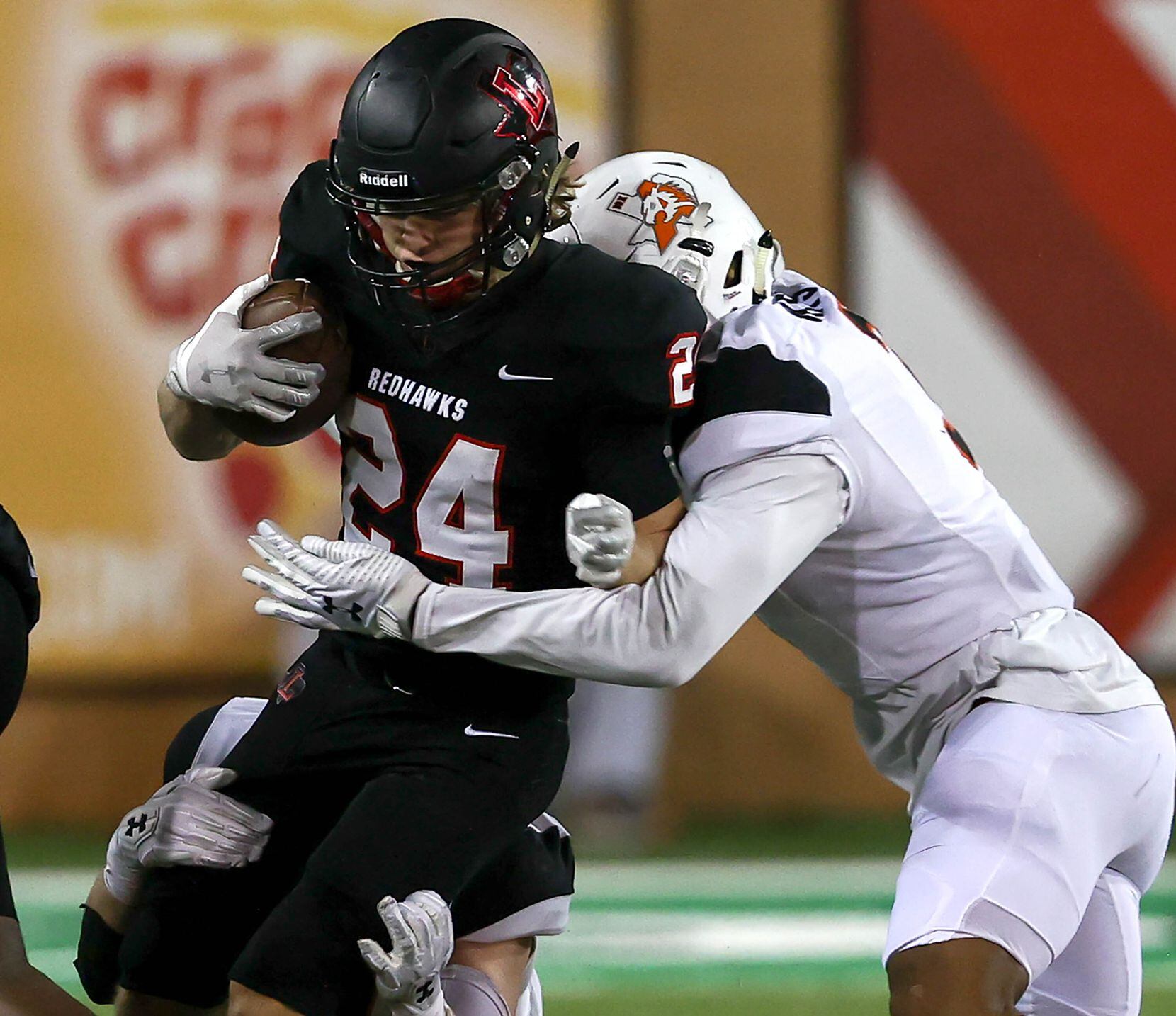 Frisco Liberty running back Jack Bryan (24) is stopped for a short gain by Aledo cornerback...