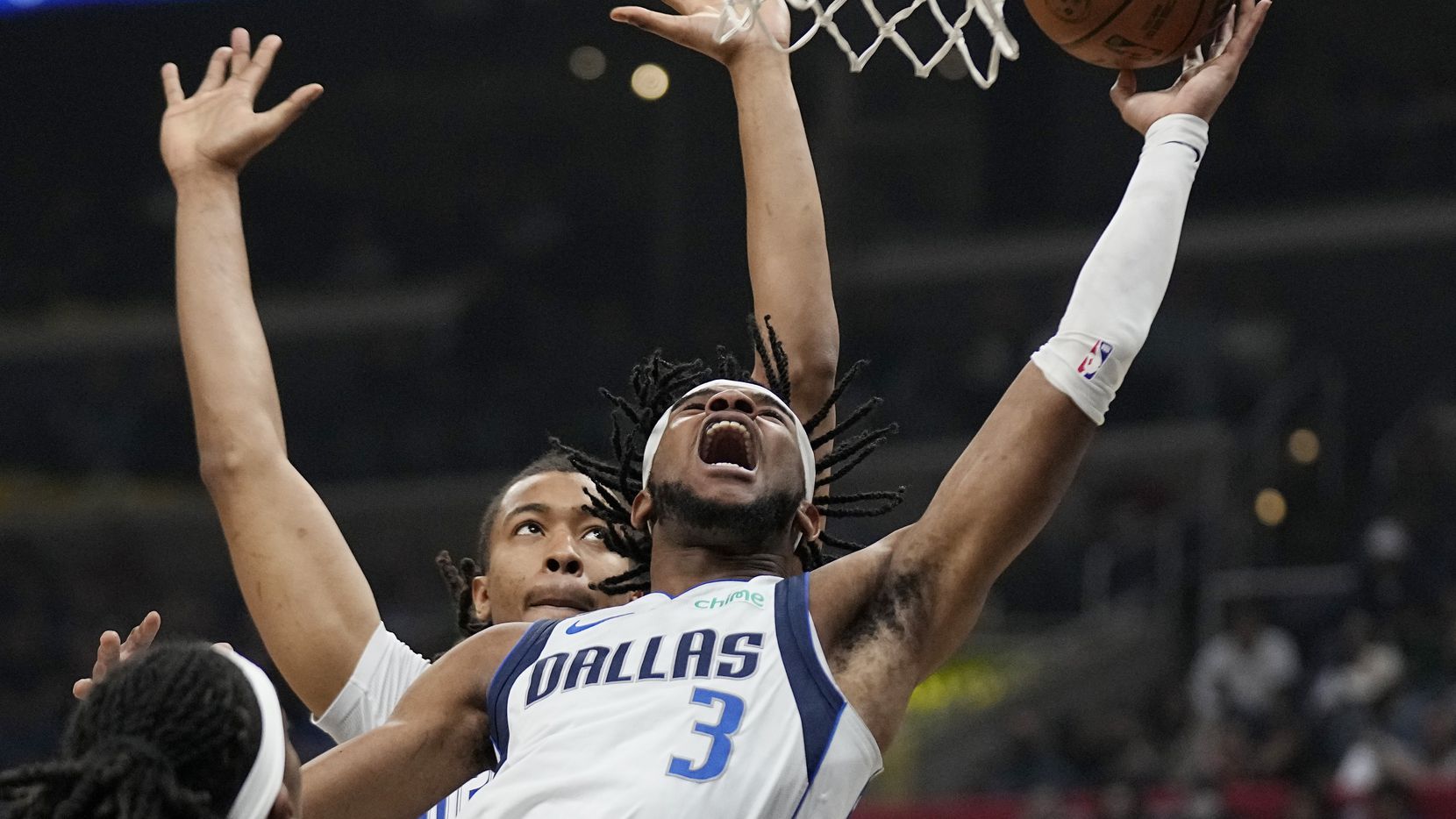 Dallas Mavericks guard Jaden Hardy, right, shoots as Los Angeles Clippers center Moses Brown...