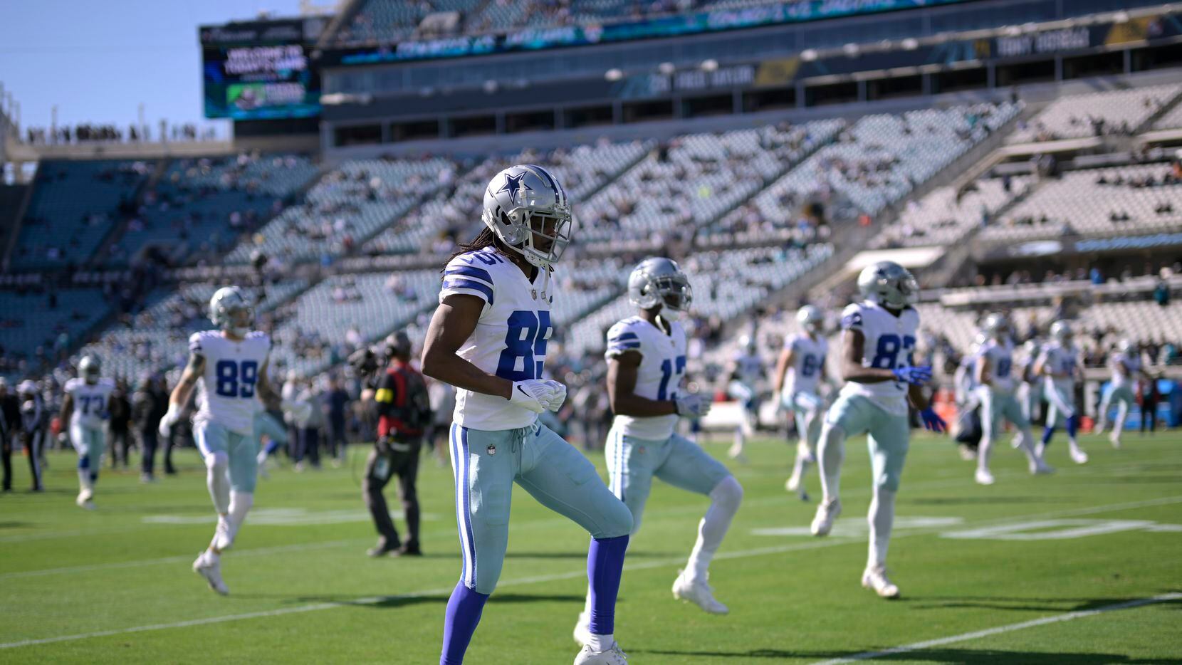Dallas Cowboys wide receiver Noah Brown (85) and teammates warm up before an NFL football...
