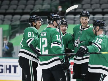 Dallas Stars forward Radek Faksa (12) is congratulated by teammates after scoring a goal during the first period of an NHL hockey game against the Nashville Predators in Dallas Sunday, March 21, 2021. (Brandon Wade/Special Contributor)