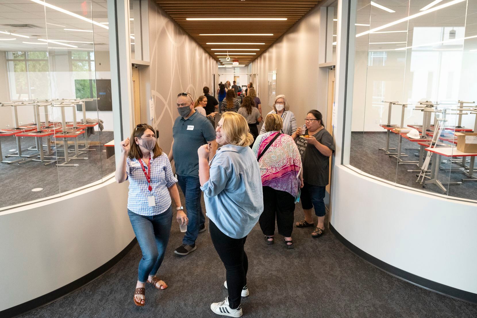 Principal Andrea Shurley (left) meets with English teacher Rachel Davies as they tour the new student building on the renovated east side campus at Ursuline Academy of Dallas on Aug. 13.