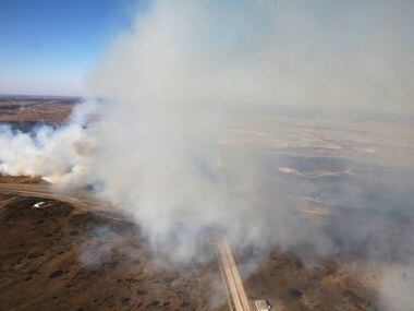 Fire crews tried to control a grass fire west of Fort Worth on Jan. 22, 2018. A massive...