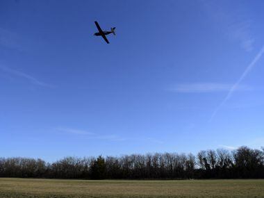 A plane takes off over the grass portion of the runway at Aero Country Airport in McKinney,...