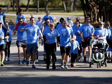 Orville Rogers, who is turning 100-years-old on Nov. 28, runs with his family near White...