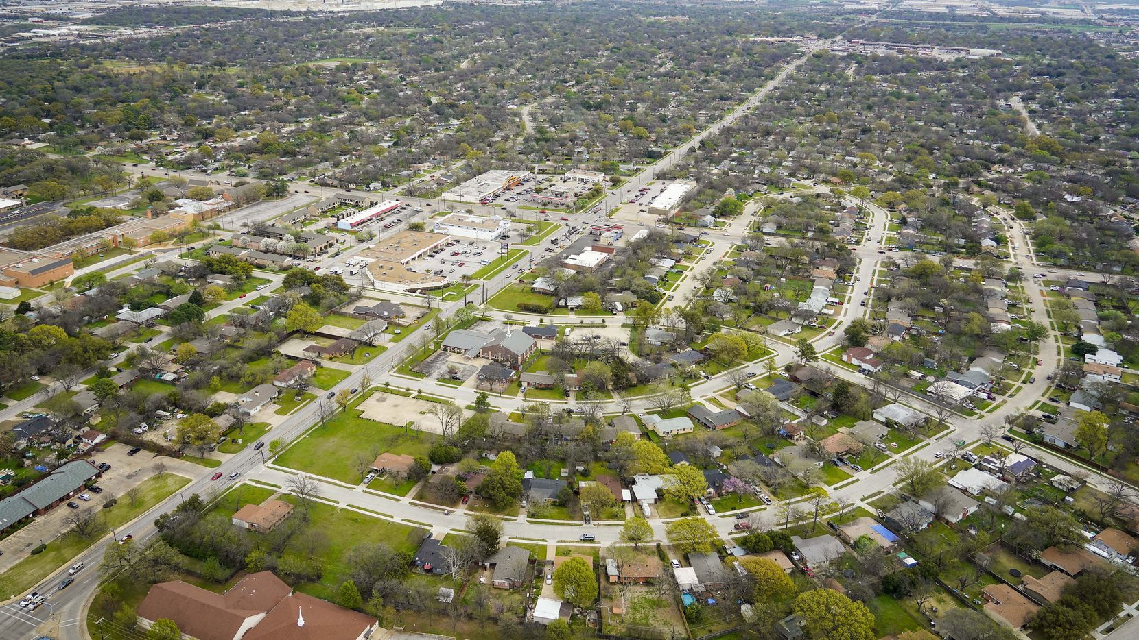 Aerial view of residential neighborhoods and retail on Thursday, March 12, 2020, in...