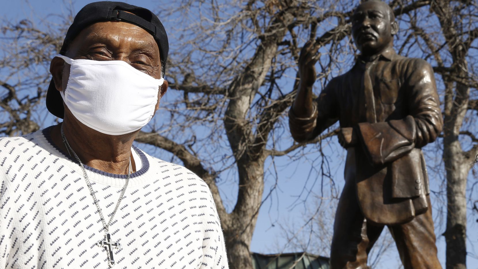 Rev. Peter Johnson poses for a portrait in front of a statue of Martin Luther King Jr. at...