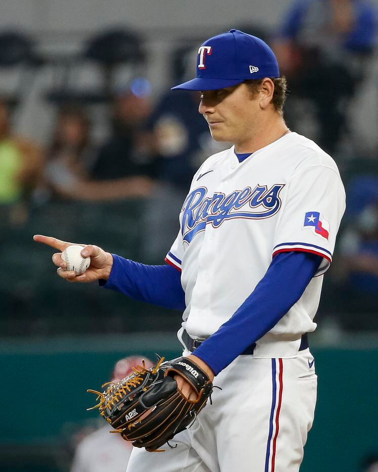 Texas Rangers starting pitcher Spencer Howard (31) signals to a teammate during the first inning against the Los Angeles Angels at Globe Life Field on Thursday, Aug. 5, 2021, in Arlington. (Elias Valverde II/The Dallas Morning News)