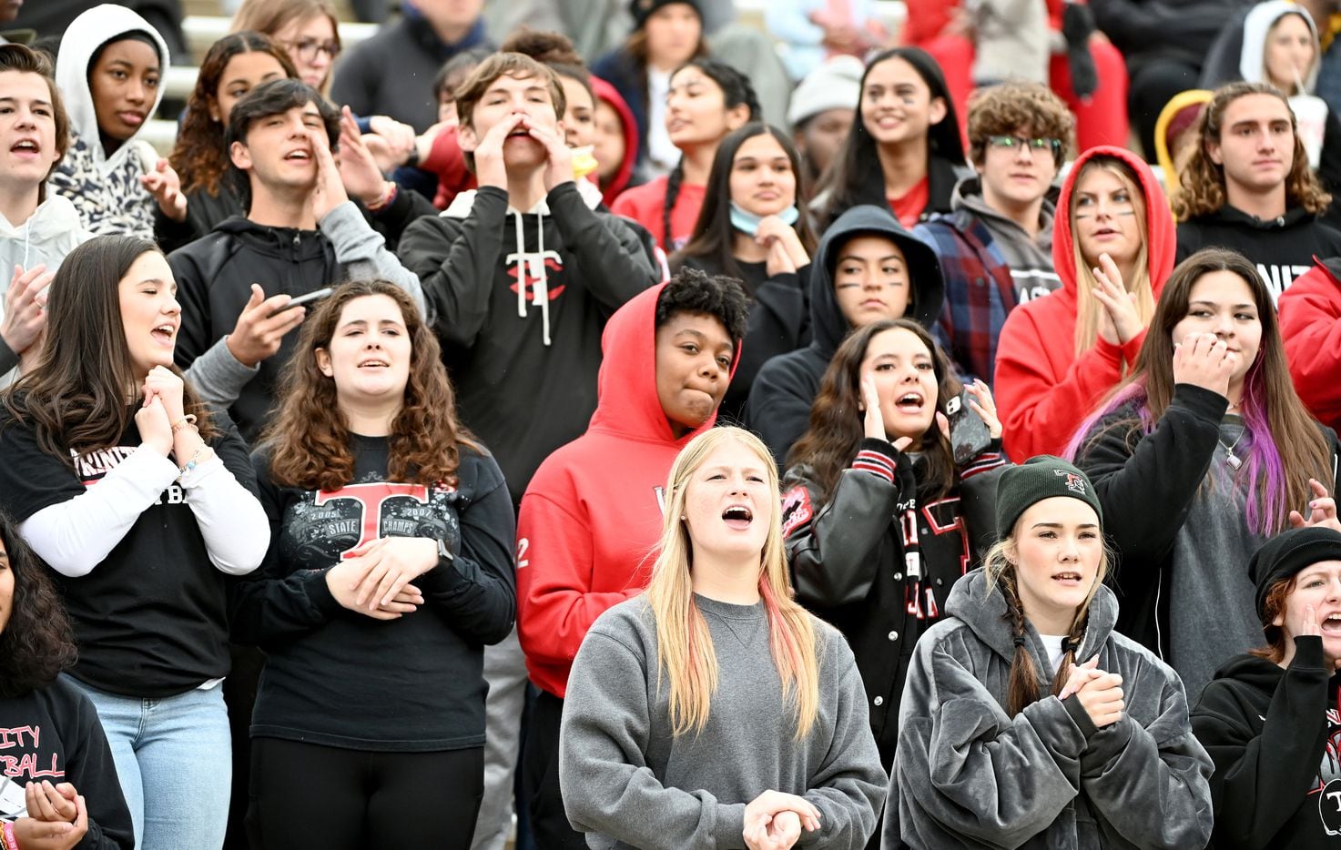 Euless Trinity students cheer in the first half of Class 6A Division I Region I semifinal playoff game between Allen and Euless Trinity, Saturday, Nov. 27, 2021, in Allen, Texas. (Matt Strasen/Special Contributor)