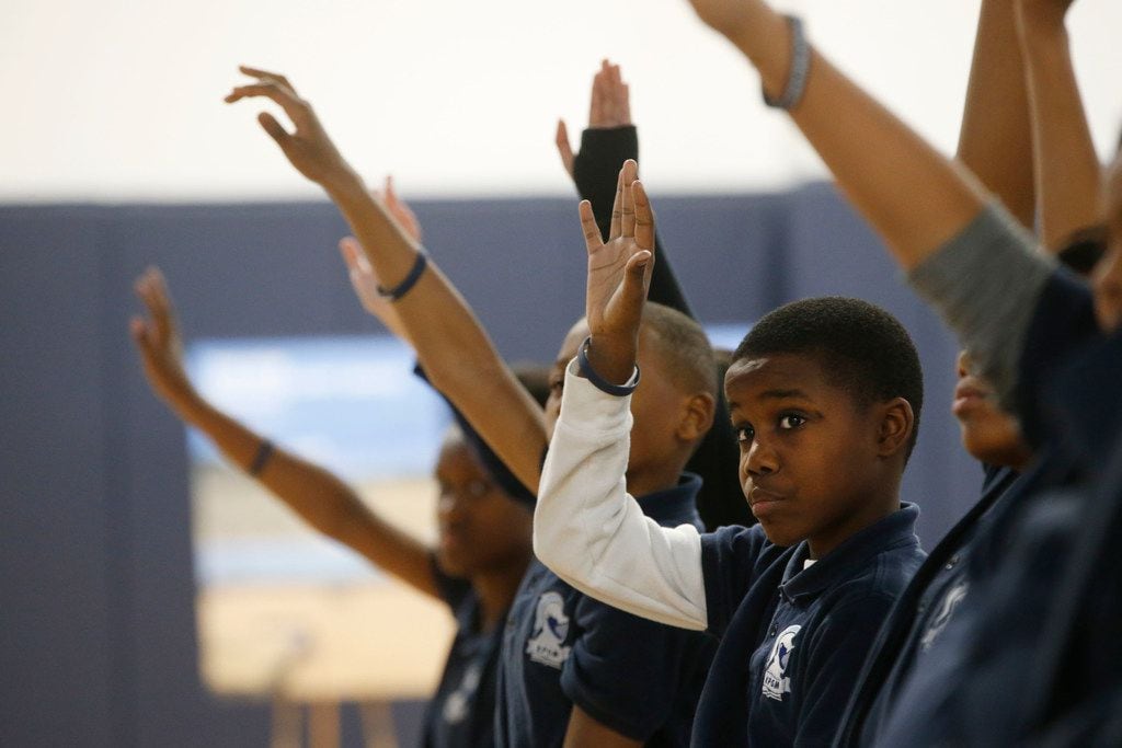 Damarte Richardson, 10, and classmates raise their hands after Andre Agassi asks which...