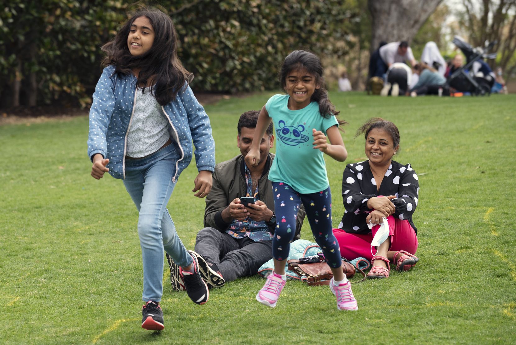 Shriya Achalia, 12, left, races with her sister Navya Achalia, 7, both of Austin, during a visit at the Dallas Arboretum for Easter weekend, on Saturday, April 03, 2021 in Dallas. The Achalia parents, Sudeep, left, and his wife Maithry, visited Dallas for the long Easter weekend to show Shriya her birth city of Plano while making several stops along the way to familiar and new sights they haven't been too in years.