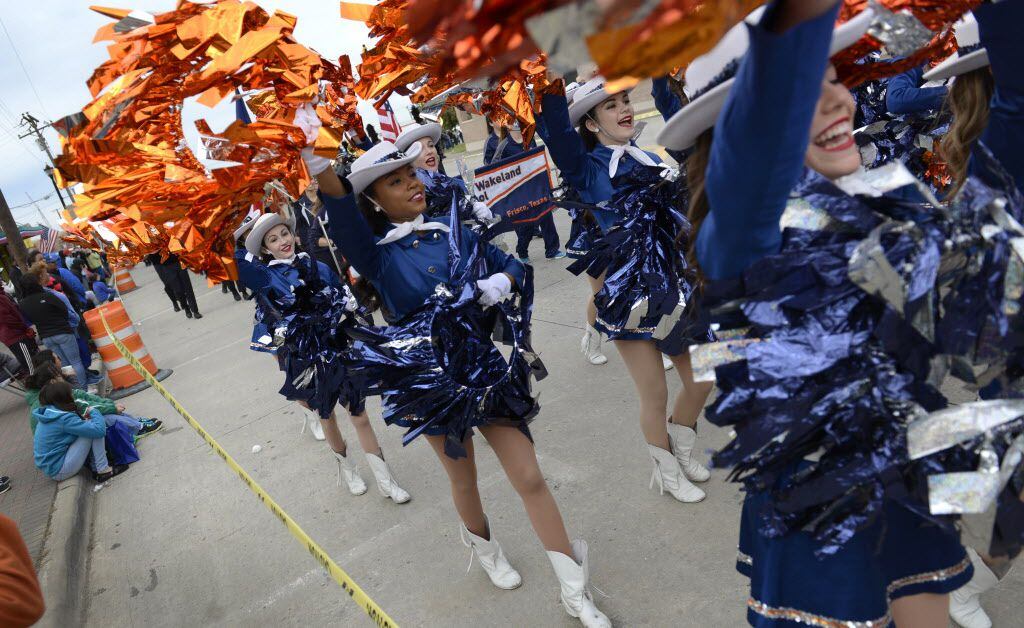 The Wakeland High School drill team marches in the Frisco Community Parade along Main Street...