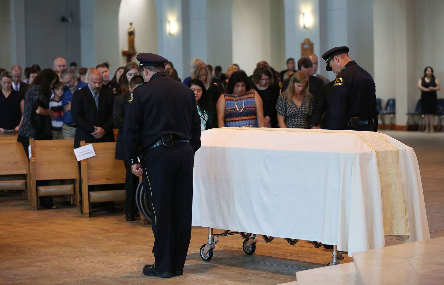 Dallas police officers stand by the casket of Dallas police sergeant Michael Smith during the funeral.