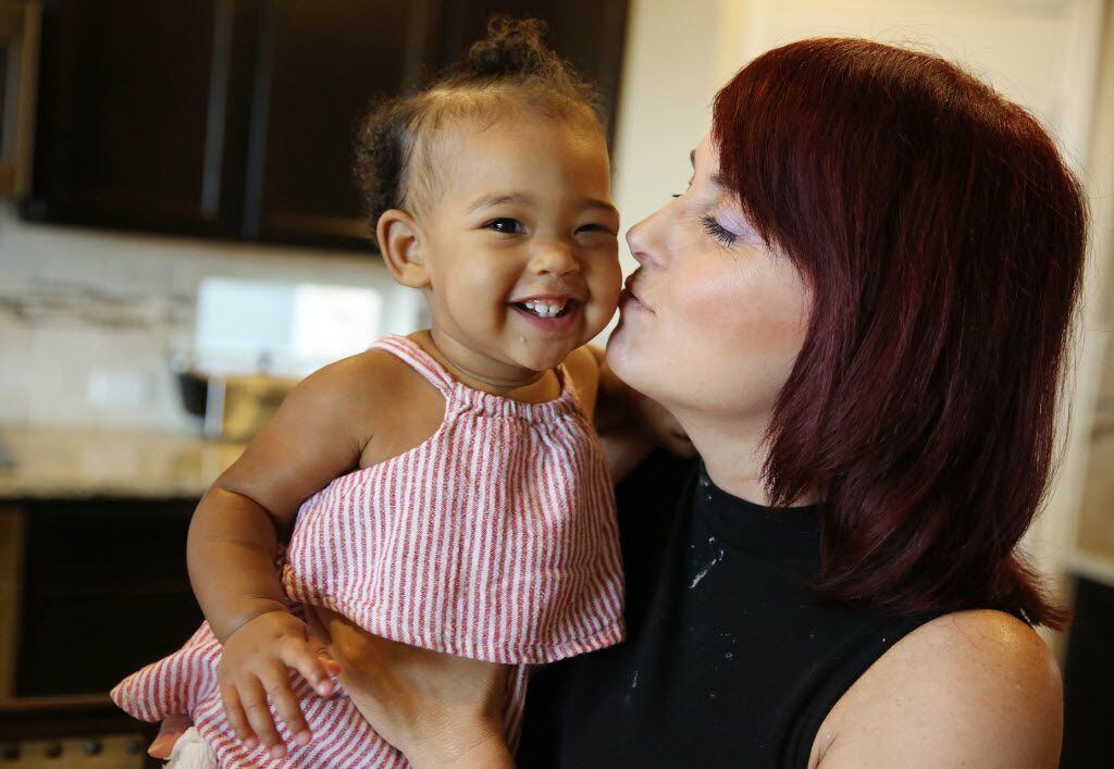 Jeannette Gainey holds her granddaughter, Brooke Lindsey (right), 10 months, after frosting...