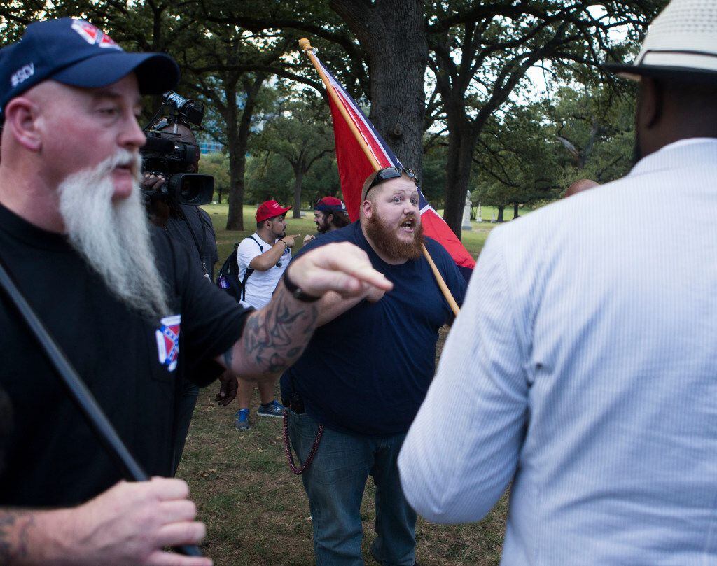 Counter-protesters Festus Allcock (left) of Fort Worth and a man who declined to provide his...